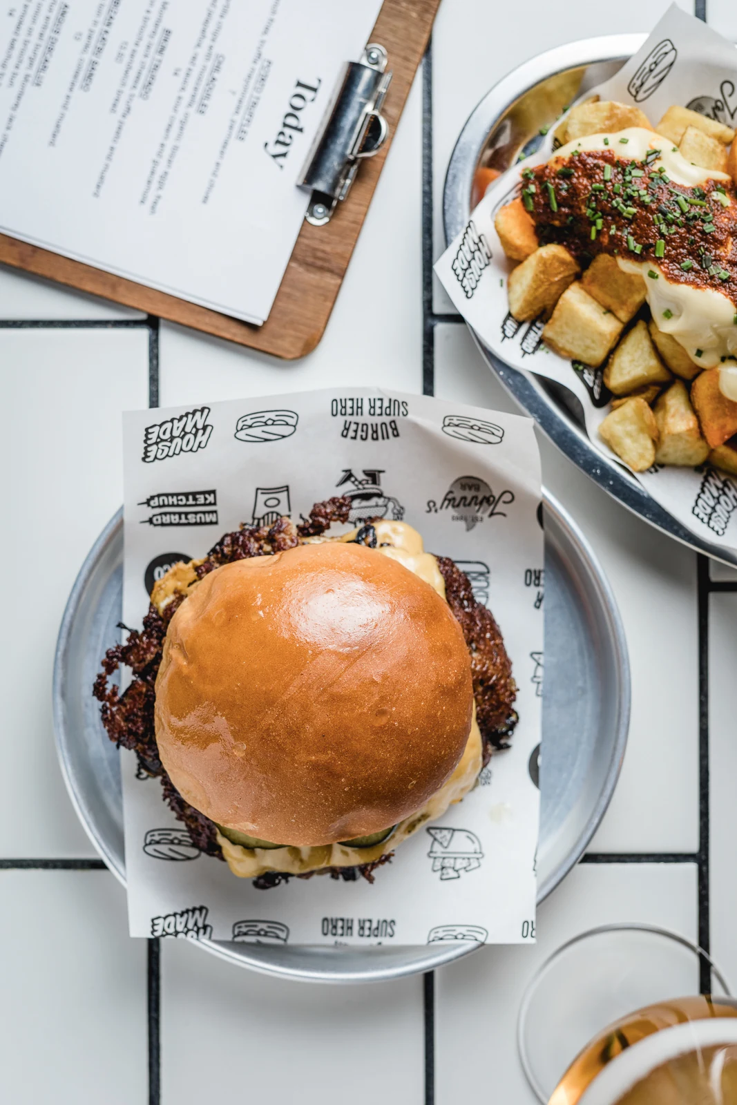 Johnny's burger with patatas bravas and the day's menu, seen from above