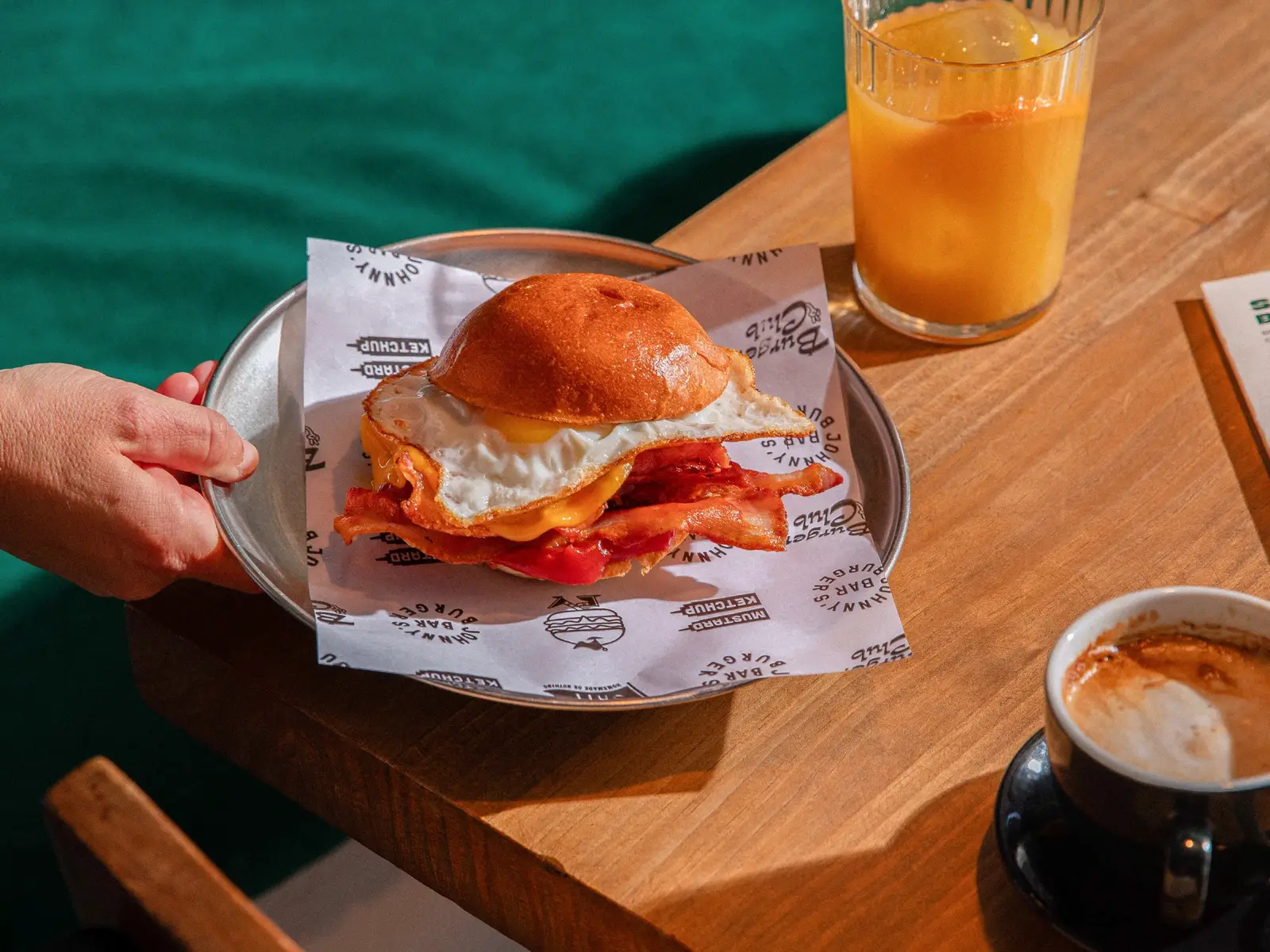 Fried egg, bacon and cheddar bun served with juice and coffee