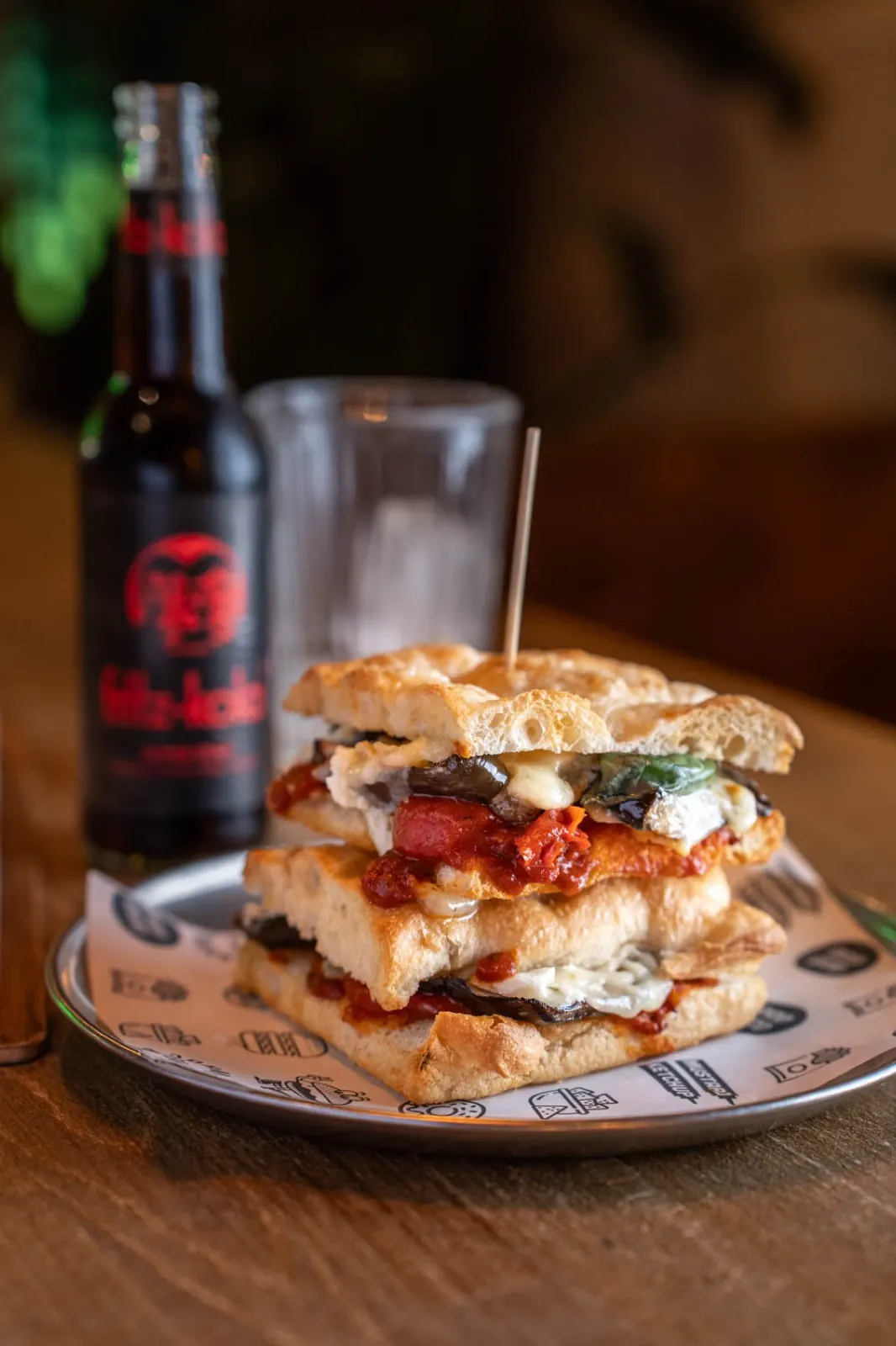 Aubergine parmigiana sandwich with craft beer